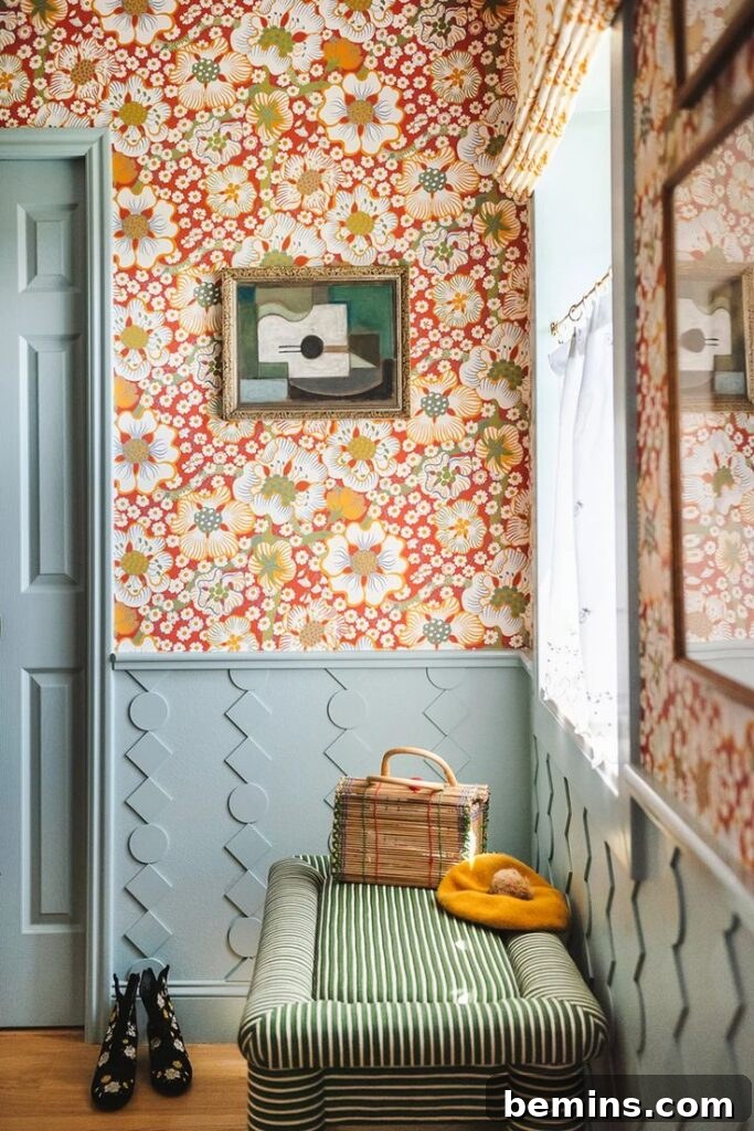 Blue wainscoting against wall with floral wallpaper in bathroom
