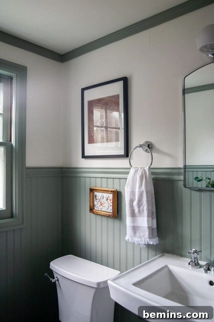 Green classic beadboard wainscoting and cream walls in bathroom