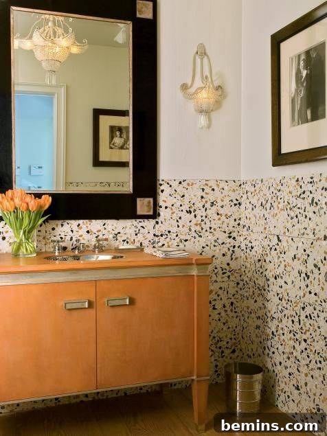 Terrazzo wainscoting in bathroom with cream wall and orange sink