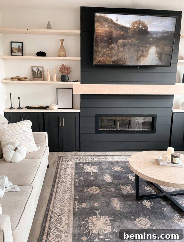 Electric fireplace with a shiplap surround and light wood mantel