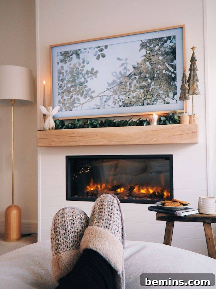 Electric fireplace against wall with wood mantel and person with crossed feet wearing house slippers