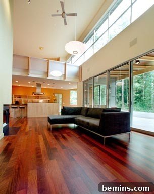Caring for Hardwood Floors: A 15-Step Guide to Longevity 2 Living room with open kitchen, glass walls and wooden floor.