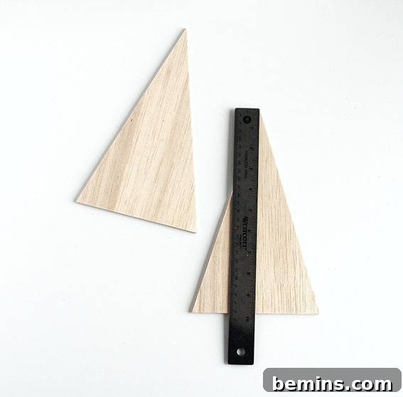 cut a triangle out of the balsa wood. Repeat this process to create a second wooden triangle