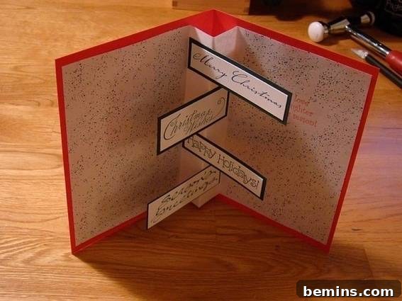 A handmade Christmas card with a clever internal greeting, showcasing intricate paper layers.