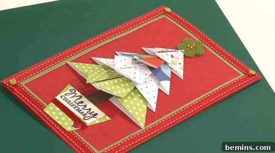 A beautiful handmade Christmas card featuring an origami Christmas tree, adding a unique 3D element.