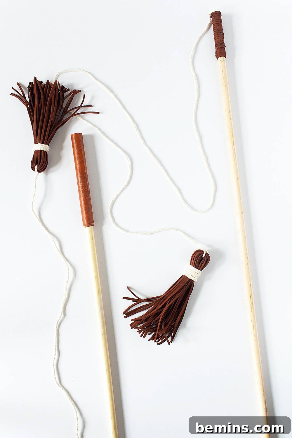 A cat playfully interacting with the DIY cat wand toy.