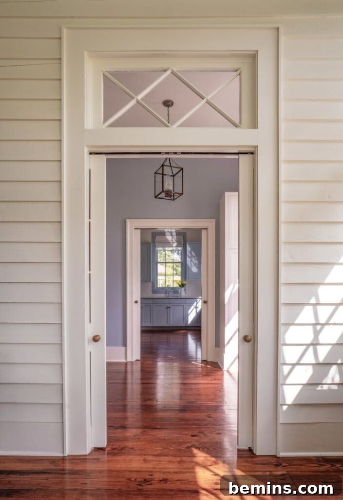 Transom Windows: A Complete Guide 12 White hallway with transom window with rectangular shape and large triangles inside
