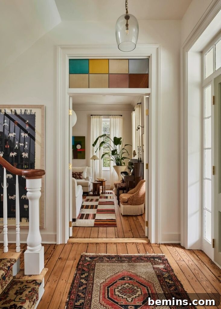 Transom Windows: A Complete Guide 13 Stained glass transom window in entryway of home with multiple colors