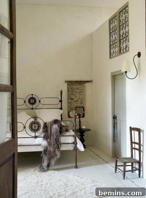An iron canopy bed draped in gauzy fabrics, creating a romantic and ethereal atmosphere.