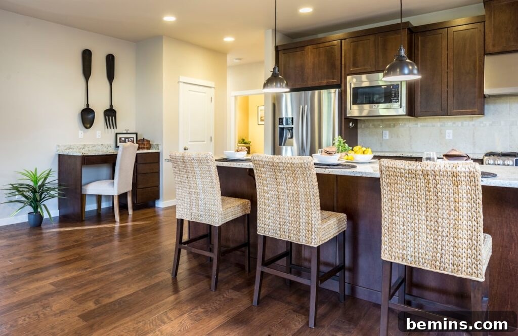 Cozy kitchen with hardwood floors and wooden chairs around the kitchen counter.