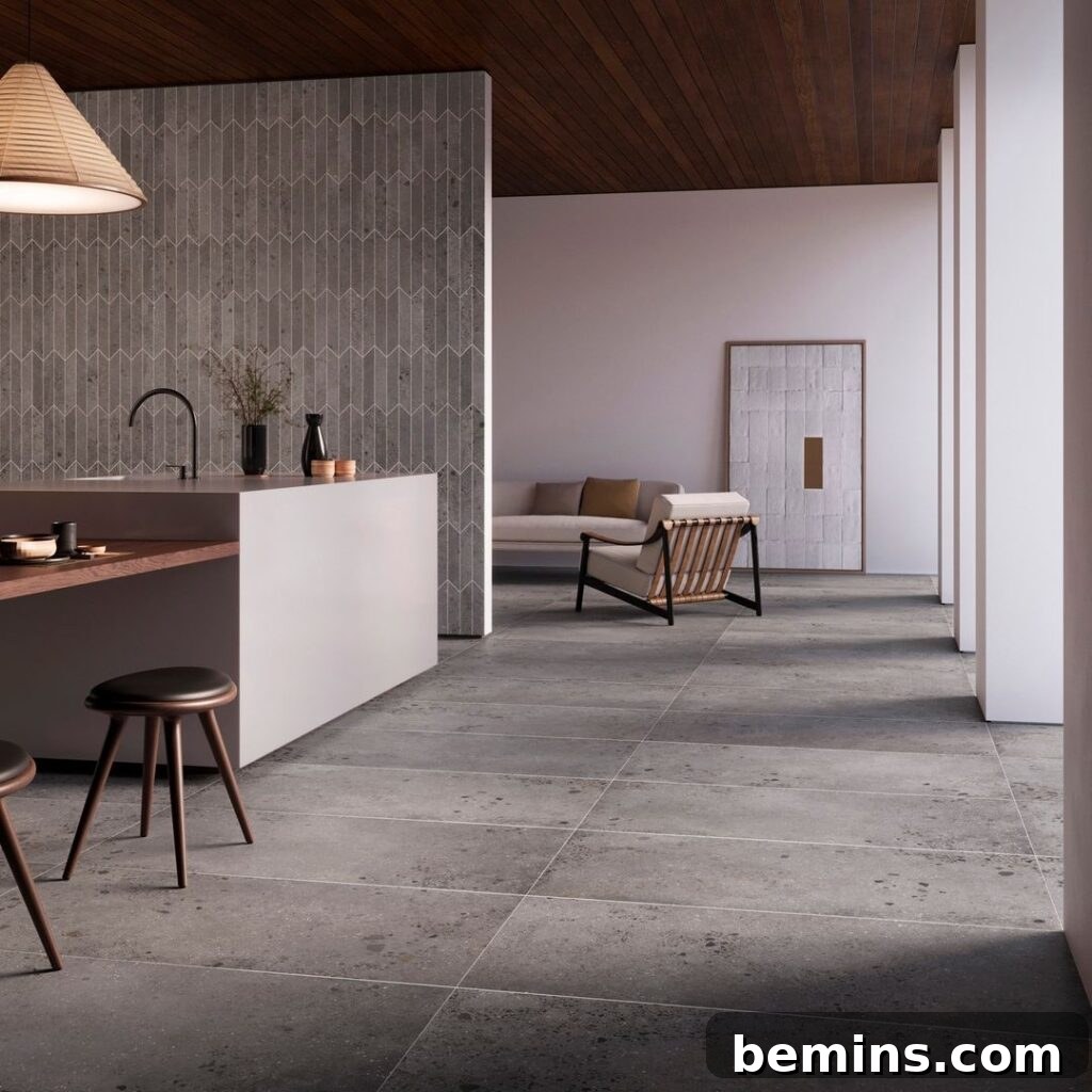 Sleek industrial kitchen featuring gray porcelain tile flooring.