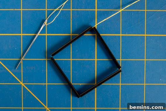 Threading Straws onto Yarn