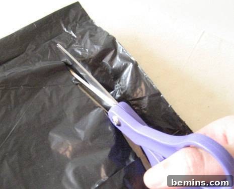 Cutting a black carry bag with lavender scissors.