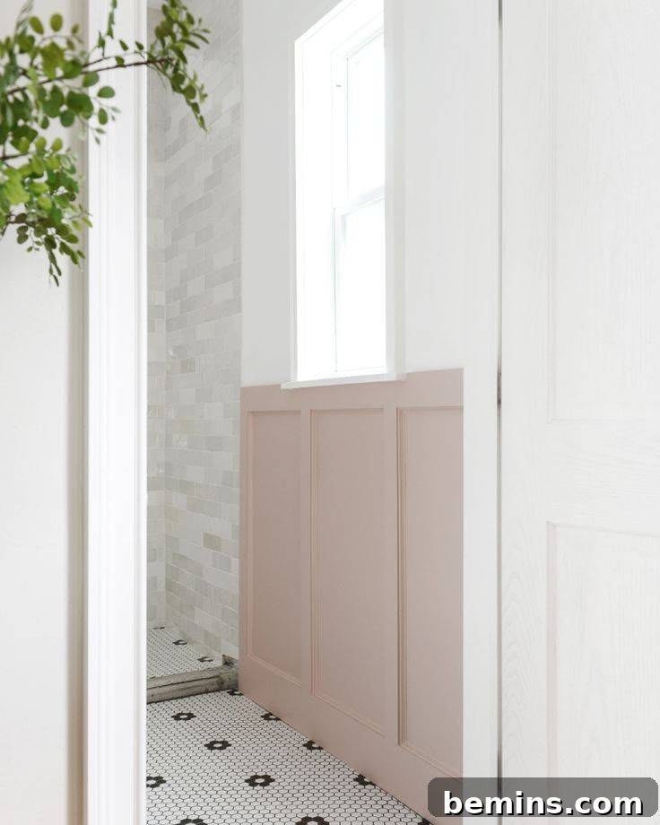 White bathroom with pink wainscoting and large window