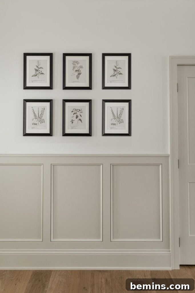 Taupe wainscoting on entryway wall with six pictures above.
