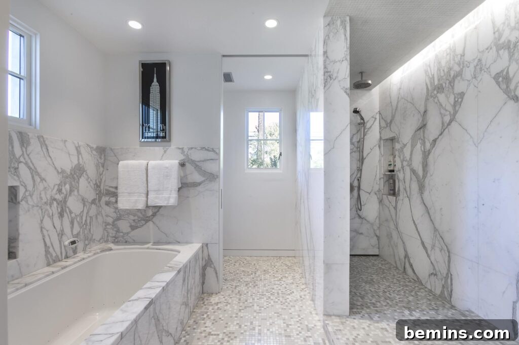 Bathroom with gray and white marble wainscoting around tub and in shower