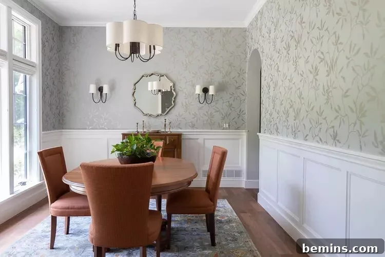 White mdf wainscoting with green wallpaper in dining room