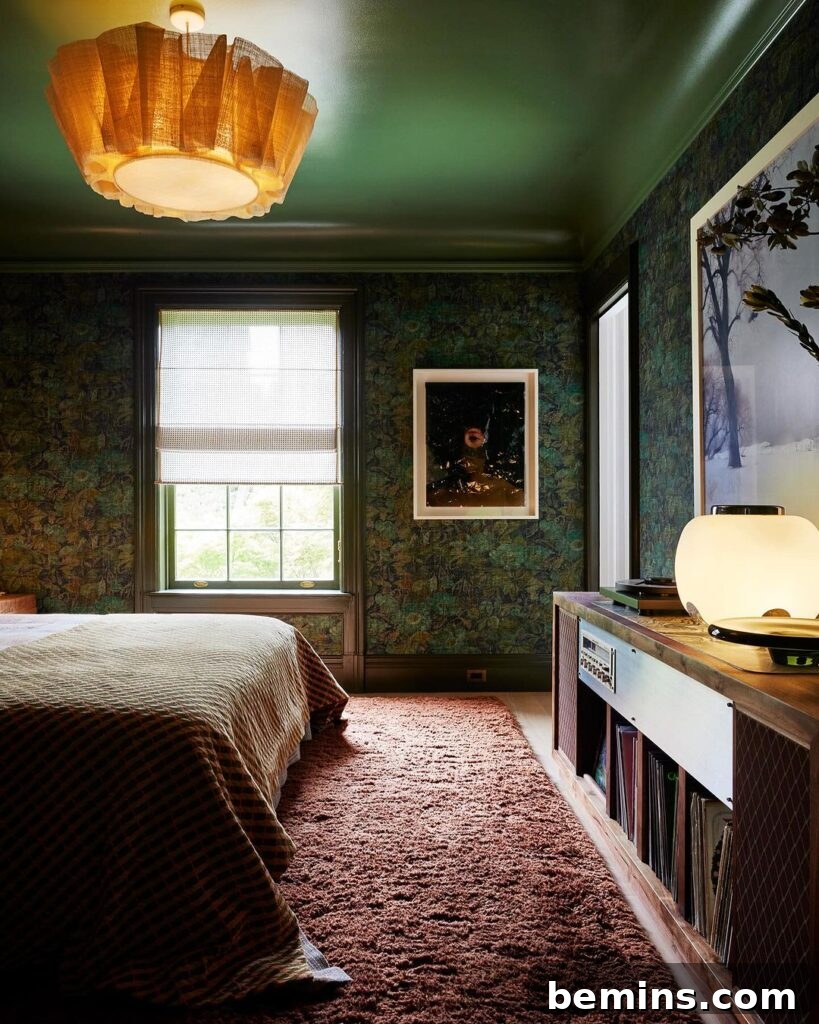 Budget Bedroom Wallpaper: Stylish Upgrades That Won't Break the Bank 19 Dark green wallpaper in a bedroom with pink floor and brown blanket