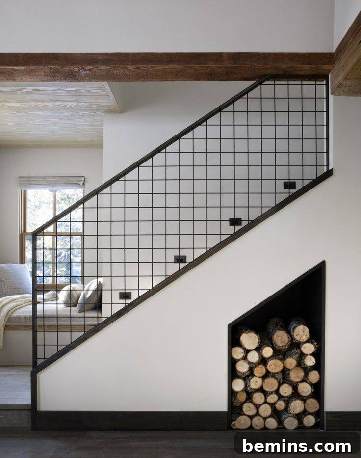 Living room stairs featuring a black railing and firewood storage underneath.