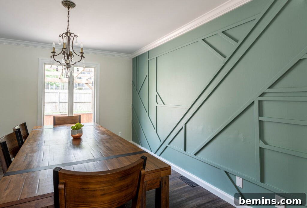 Inspiring Wainscoting: 15+ Dining Room Design Ideas 18 Seafoam green accent wall with geomteric shapes in dining room