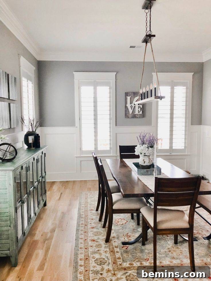 Inspiring Wainscoting: 15+ Dining Room Design Ideas 10 Large dining room with dark brown table gray walls and white wainscoting.