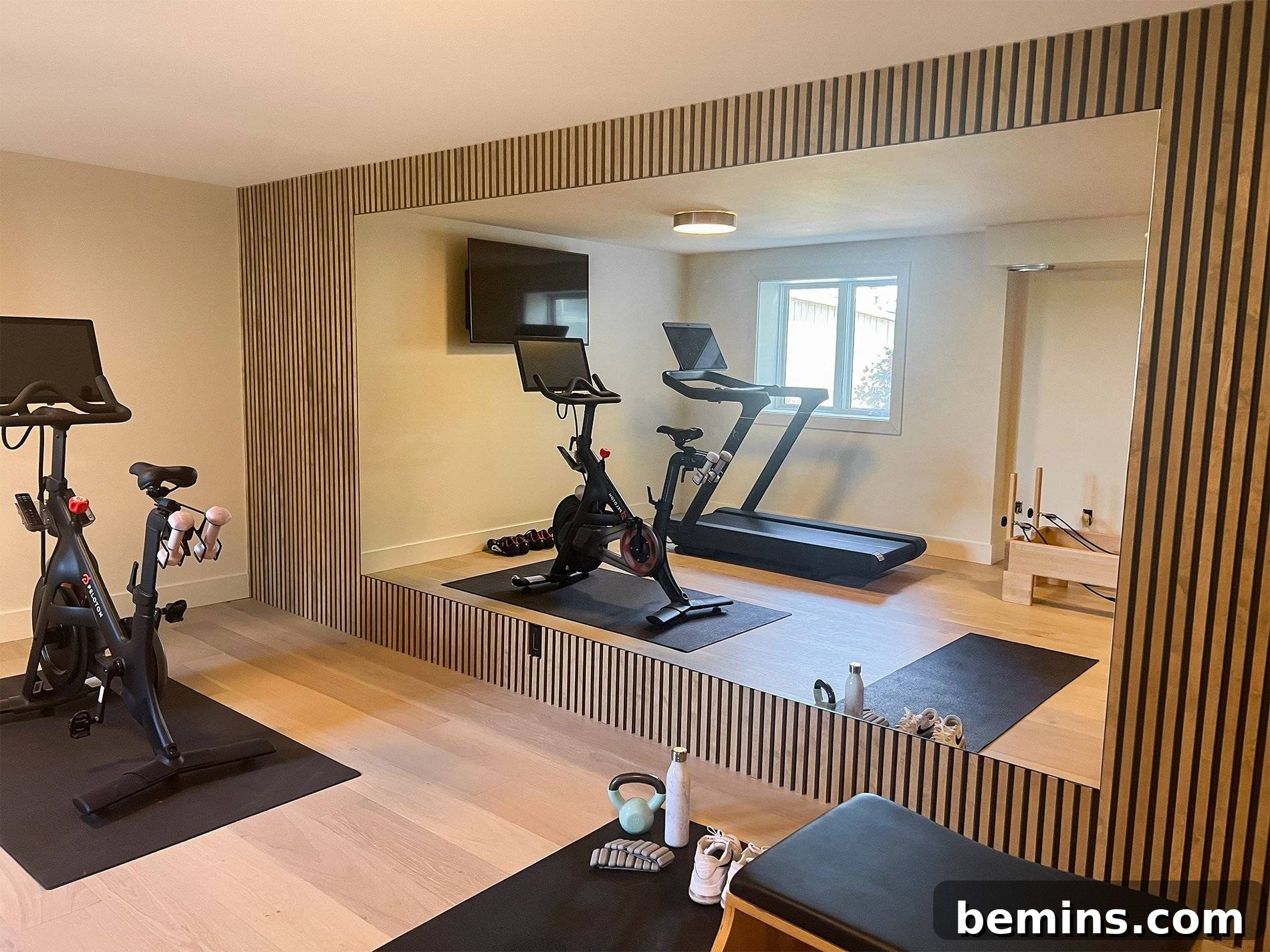 Elevate Your Workout Space: Inspiring Home Gym Designs 8 Basement gym with treadmill and elliptical machine on hardwood floor