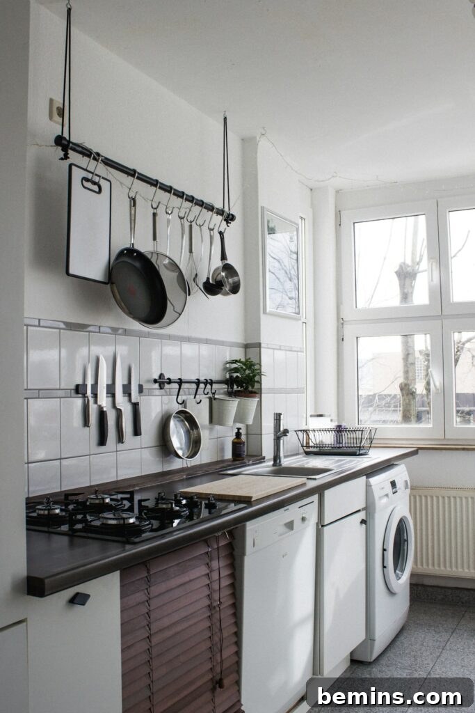 A white dishwasher, illustrating efficient use of space in a small kitchen.