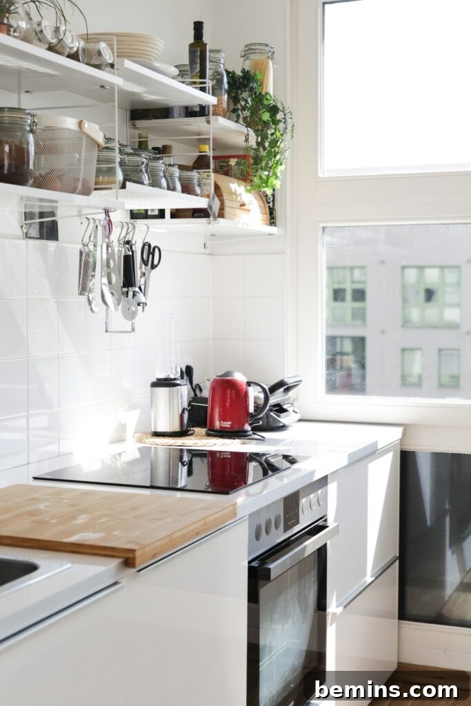 White wooden kitchen cabinet with a sink, illustrating efficient kitchen design.