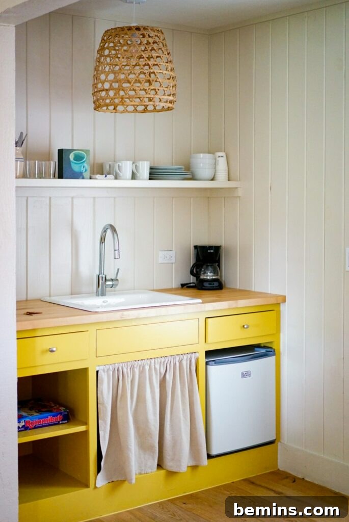 White and brown wooden cabinet in a well-organized small kitchen.