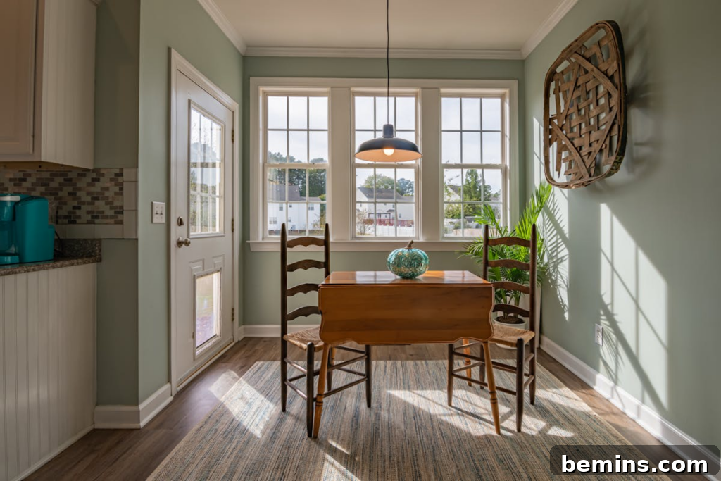 Bright dining area with wooden furniture and large windows showcasing natural light.