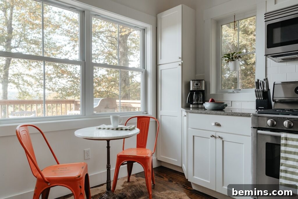 A kitchen with a table and two chairs, optimizing space and functionality.