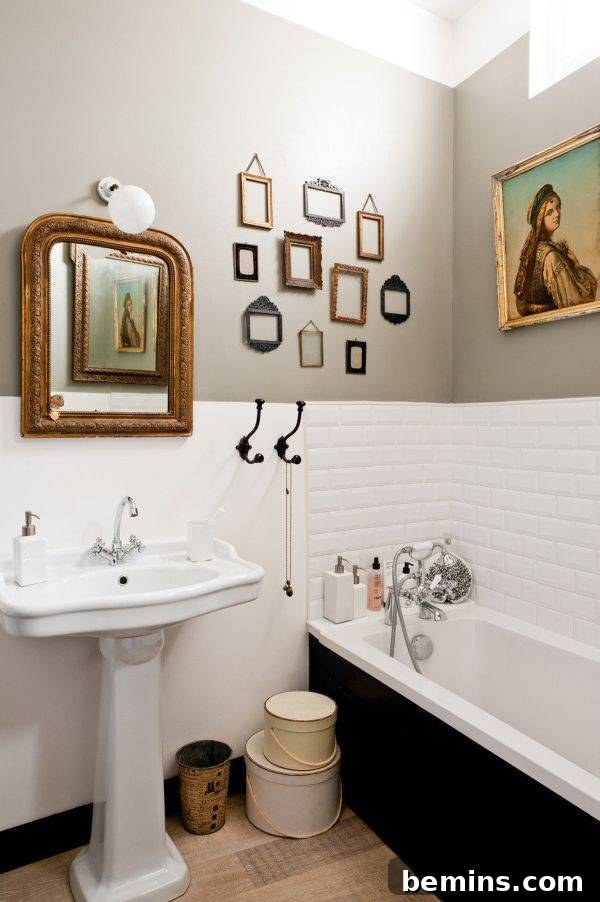 Command Strips Unleashed: Gallery Walls Without the Nail Holes 13 Bathroom with white tiles and small frames on wall, showing how Command Strips can personalize even the smallest spaces.
