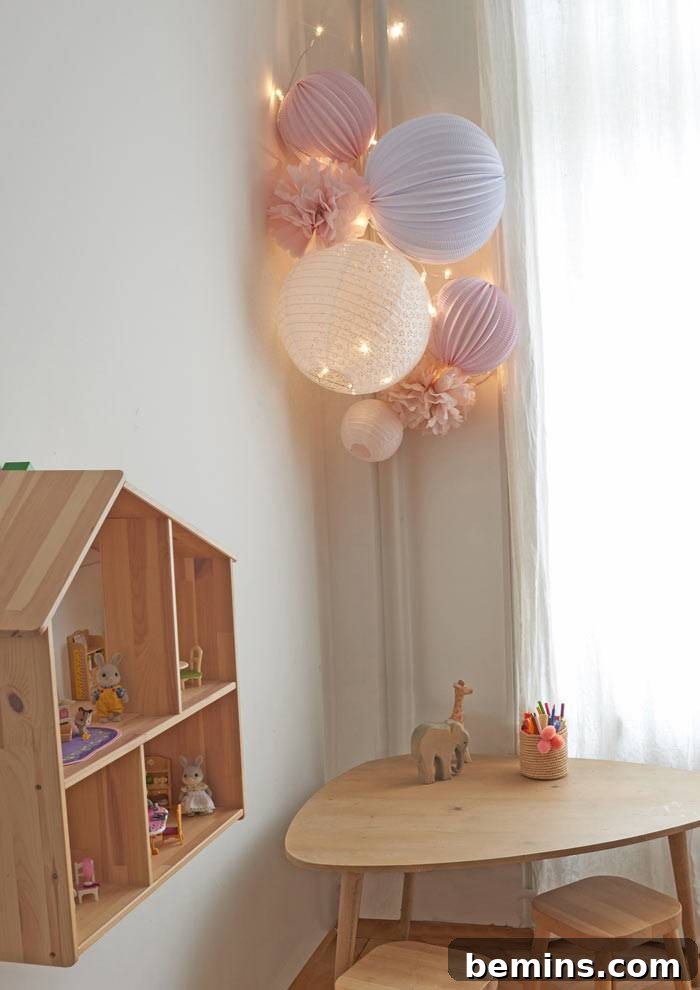 Command Strips Unleashed: Gallery Walls Without the Nail Holes 14 Pink and blue paper lanterns in room over wood desk, creating a playful and damage-free decorative element.