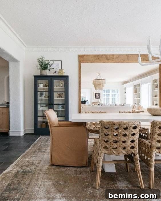 Rattan dining seats at white dining table with brown upholstered chair