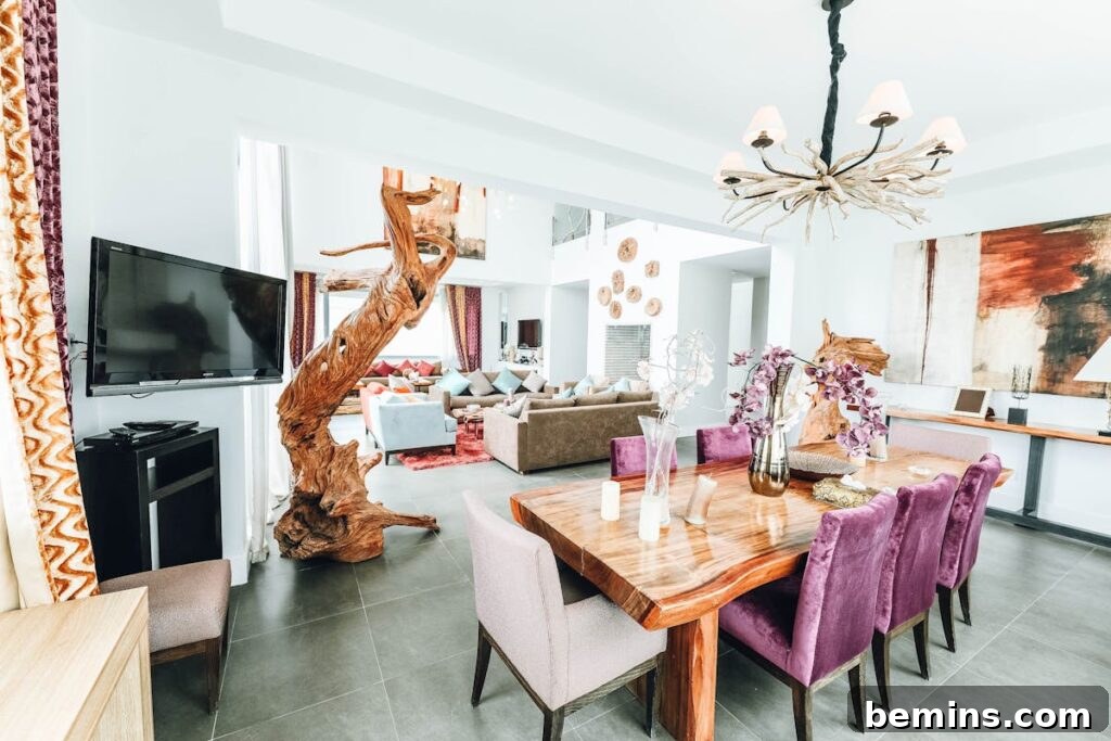 Stylish indoor dining room featuring modern decor with chandelier and artistic elements.