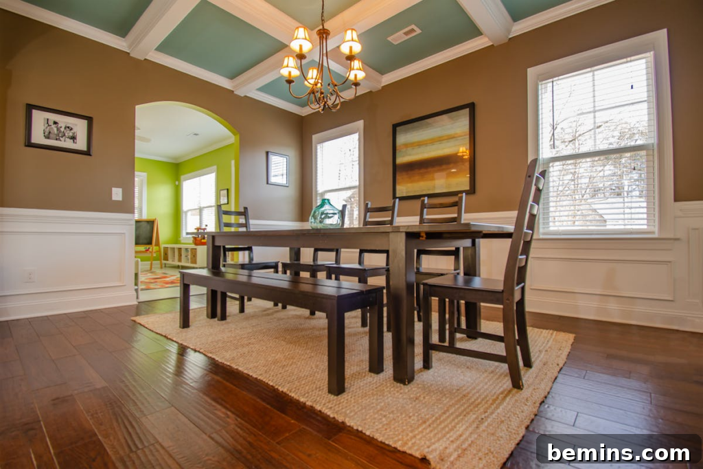 Stylish dining room featuring modern wood furniture, large windows, and artistic decor.