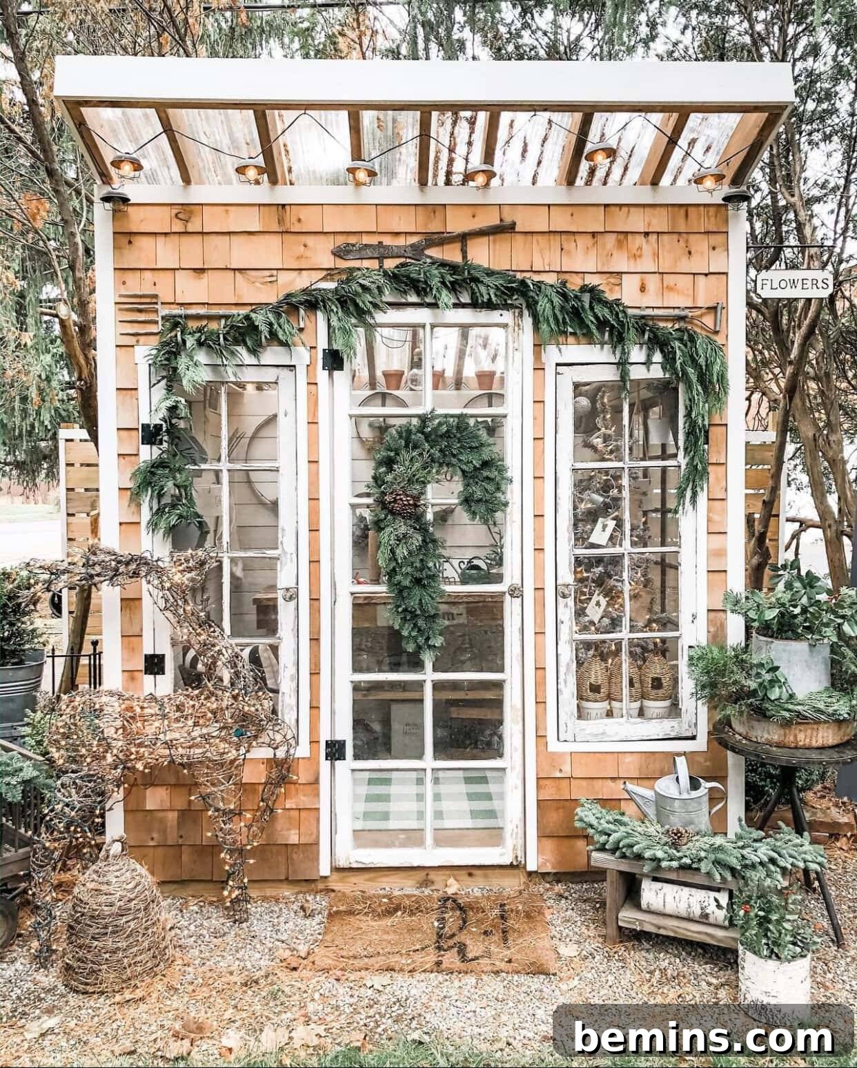 Brown garden shed with white doors and green wreath