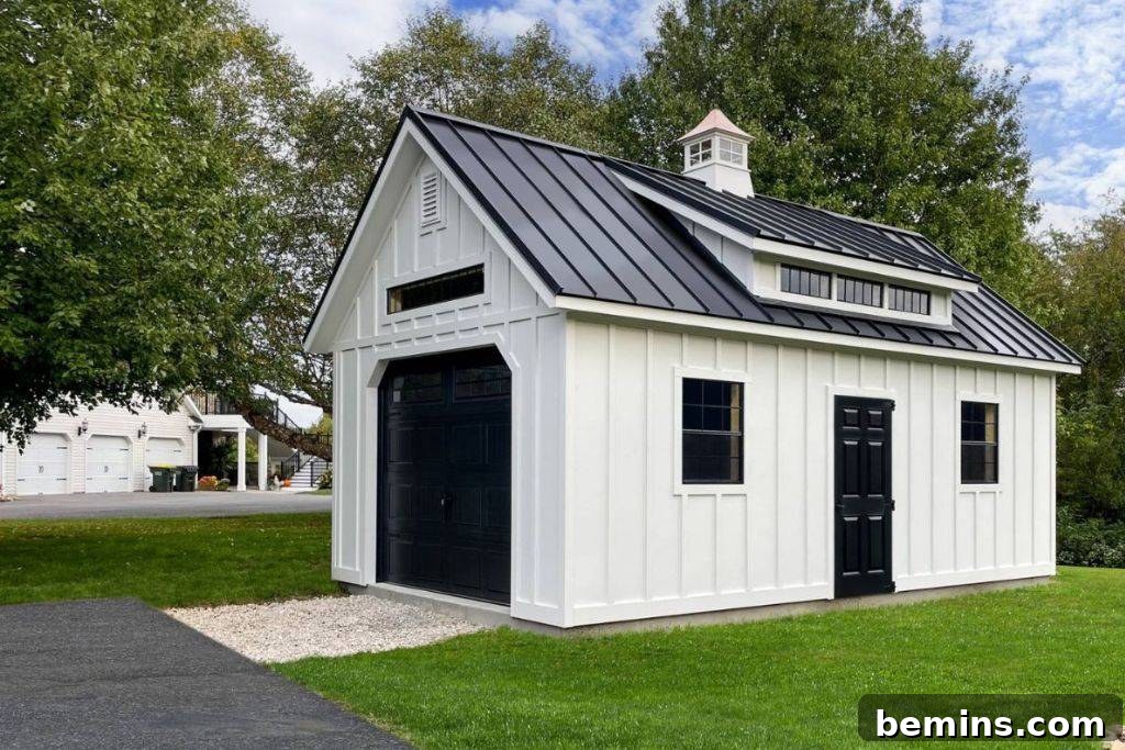 White shed with black garage style door in yard