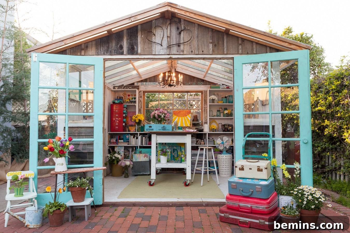 Brown shed with turquoise doors with art studio supplies inside