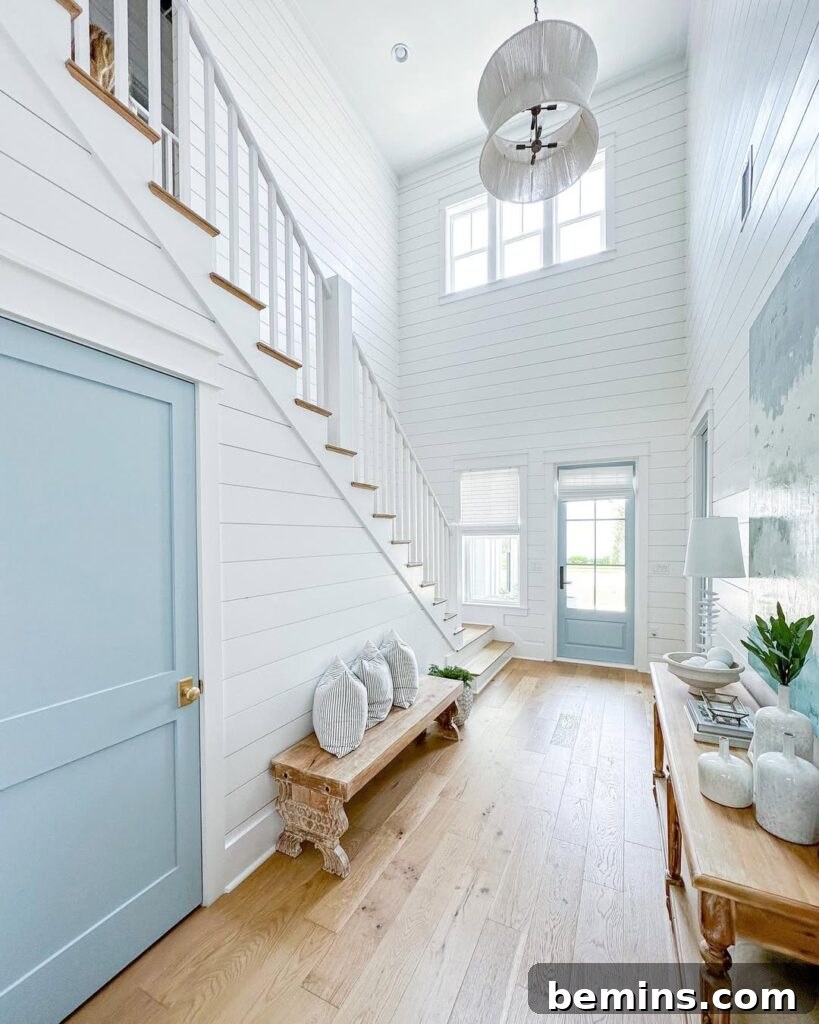 Elevate Your Entryway: Stunning Foyer Design Inspirations 2 Large white home interior with brown wood console table in foyer