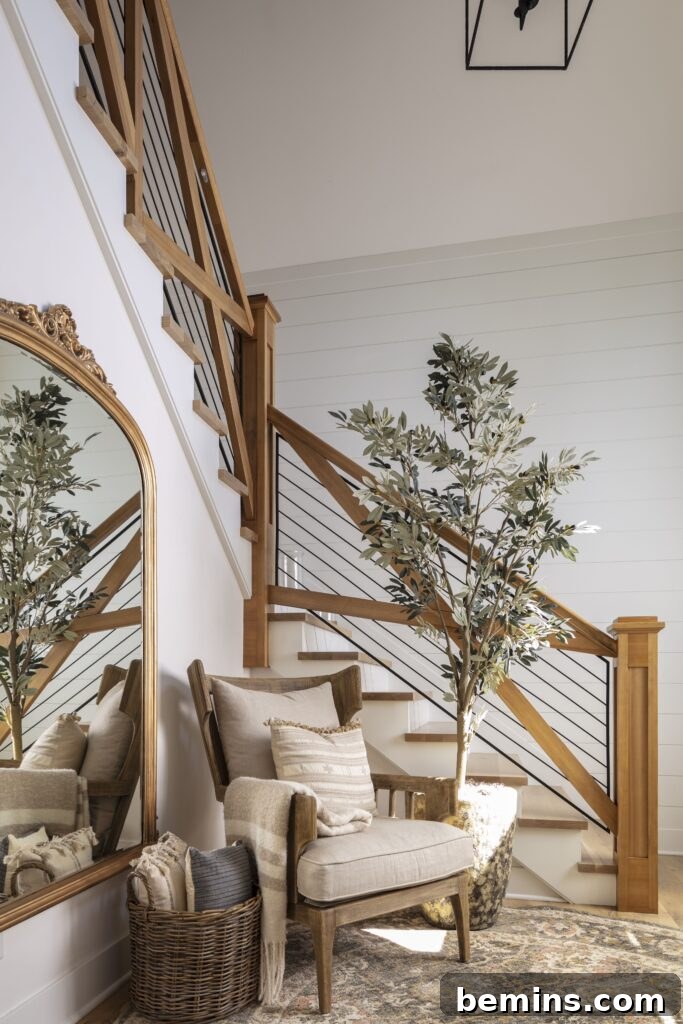 Elevate Your Entryway: Stunning Foyer Design Inspirations 14 Stairs with cream chair and large plant next to it
