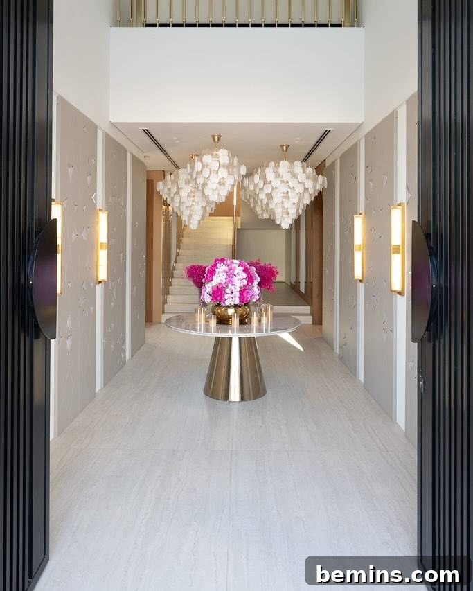 Elevate Your Entryway: Stunning Foyer Design Inspirations 5 Large foyer area with gold table and gold and white hanging lights