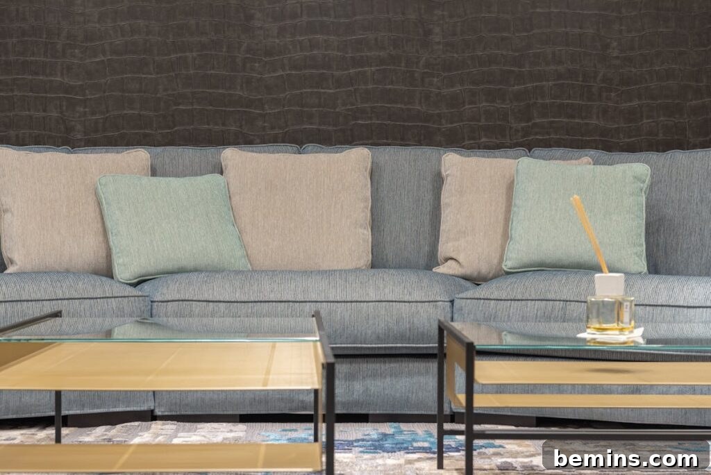 Effortless Home Oasis: Your Guide to a Summer Staycation 3 Comfortable gray sofa with soft cushions near coffee tables with glass tabletops in modern living room
