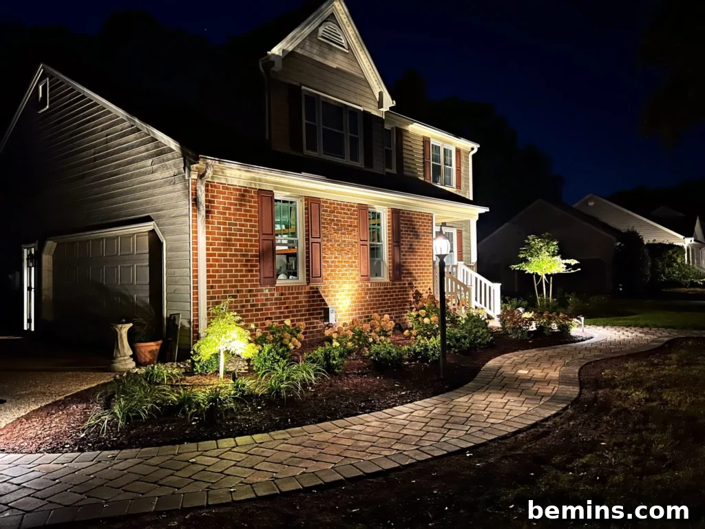 Transform Your Garden with Brilliant Uplighting Designs 2 Home at night with accent lighting on the side and trees