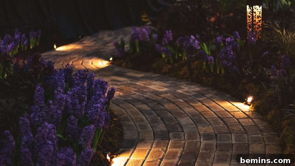 Transform Your Garden with Brilliant Uplighting Designs 16 Subtle in-ground uplights illuminating a garden bed with purple flowers
