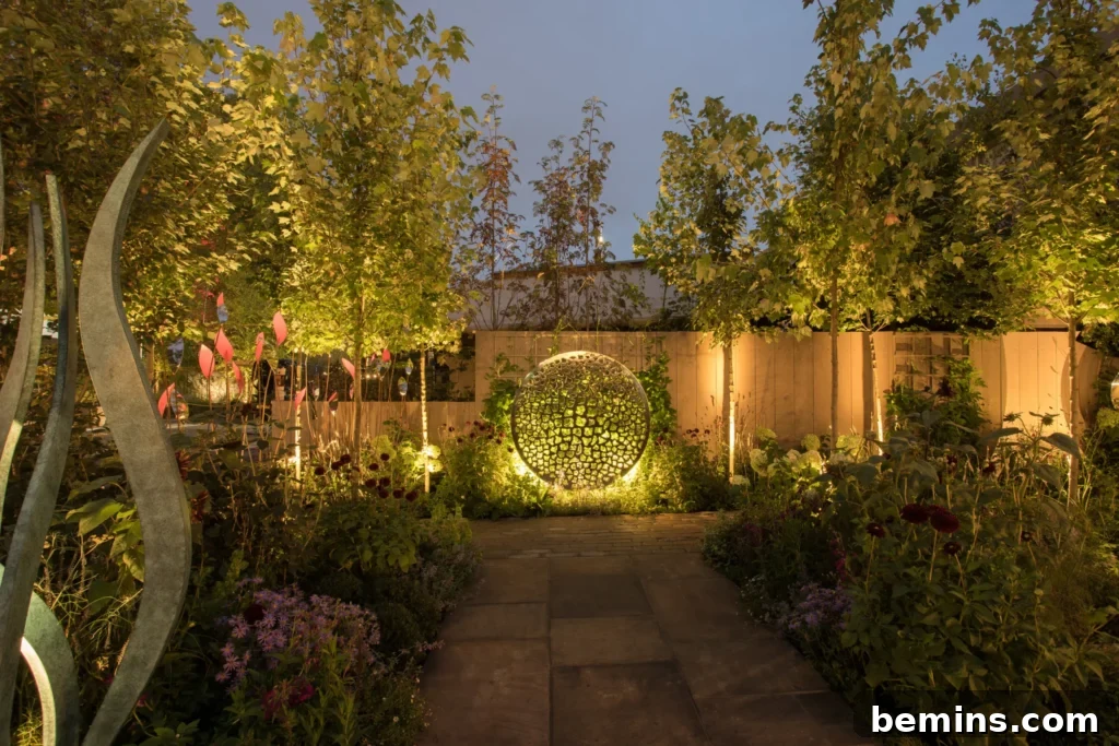 Transform Your Garden with Brilliant Uplighting Designs 19 Garden with a wide path and subtle uplights framing the flower beds