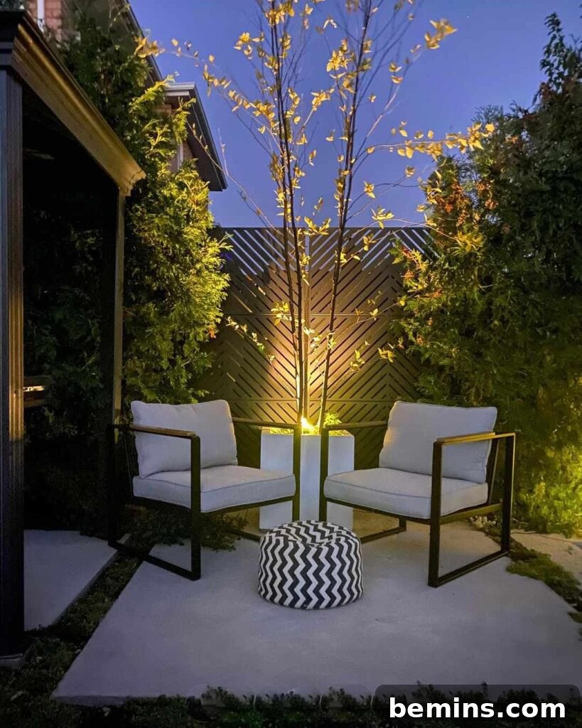 Transform Your Garden with Brilliant Uplighting Designs 20 Backyard with two white chairs and an uplight illuminating a metal wall, creating a stylish ambiance