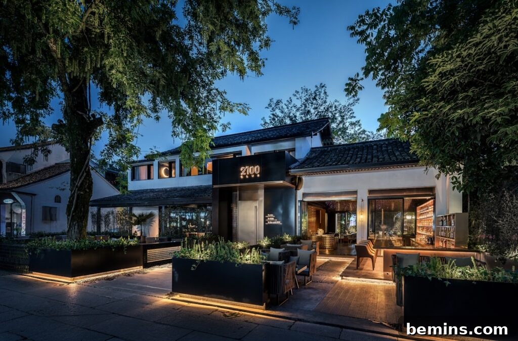 Transform Your Garden with Brilliant Uplighting Designs 4 lighted house beside trees with warm uplighting