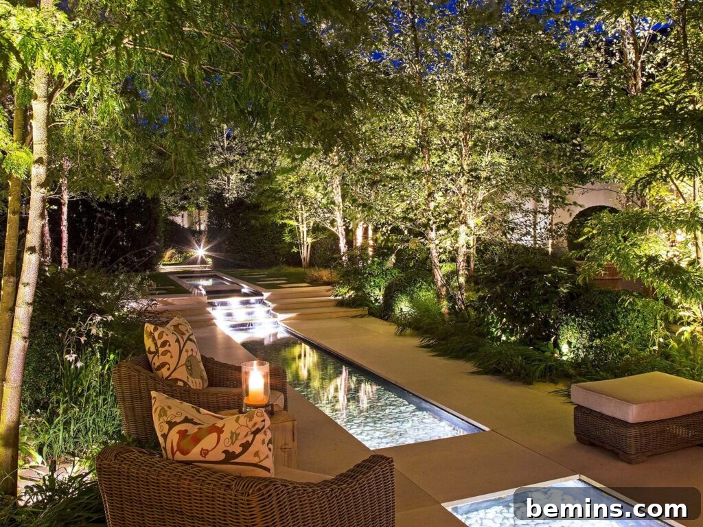 Transform Your Garden with Brilliant Uplighting Designs 6 Outdoor yard with illuminated trees at night