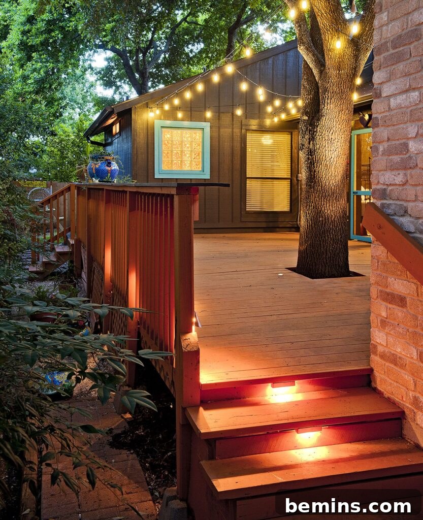 Transform Your Garden with Brilliant Uplighting Designs 10 Brown deck with uplights and a large illuminated tree